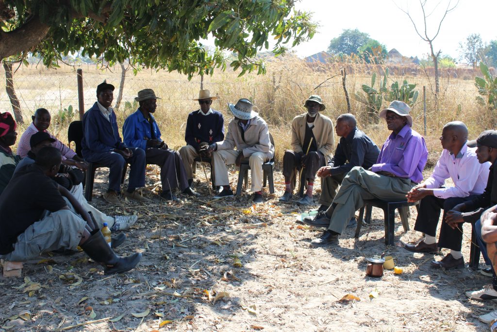 elderly men seated in semi-circle