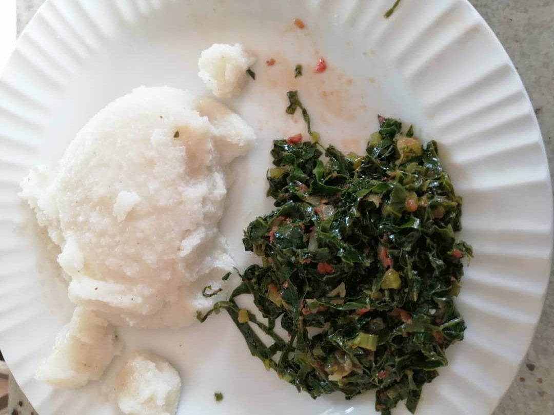 sadza and green vegetables on a plate